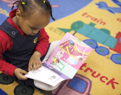Kindergarten student reading a picture book
