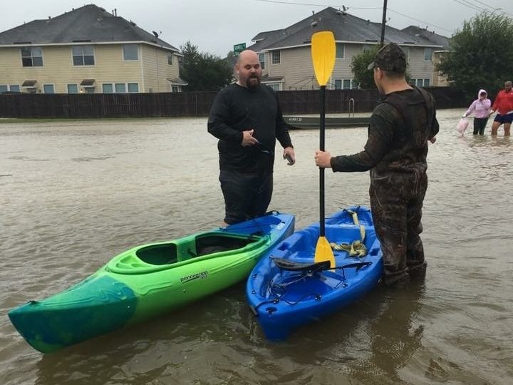 KIPP Explore counselor Brandon McElveen with kayak in flood water