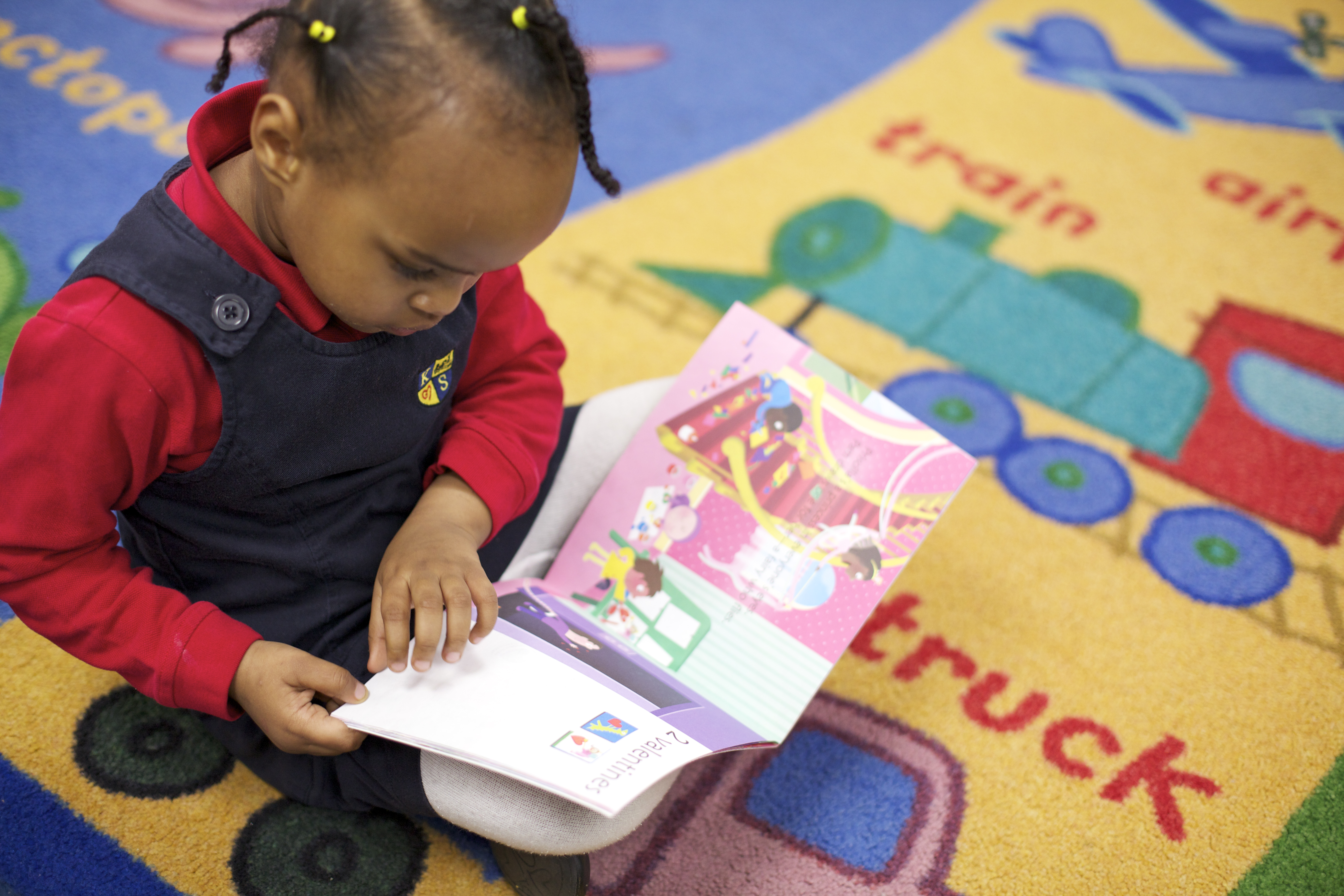 Kindergarten student reading a picture book