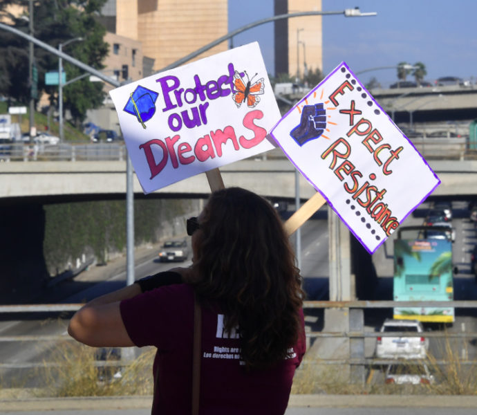 Woman holding signs saying 