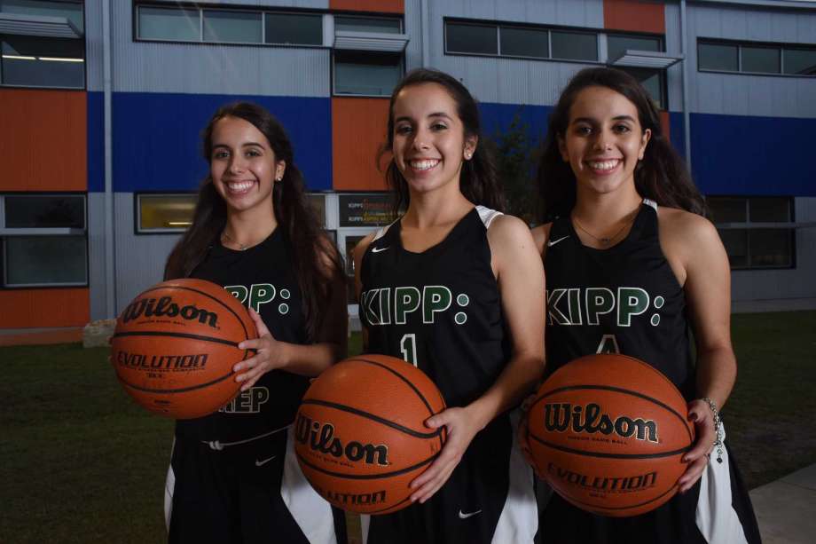 Triplets Alyssa, Breanna, and Cierra Cadena wearing KIPP jerseys and holding basketballs