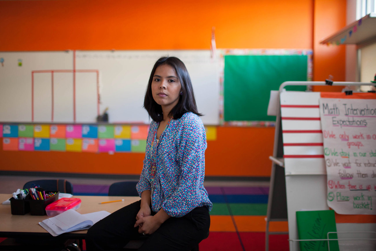 KIPP Esperanza teacher Maria Rocha in a classroom with orange walls