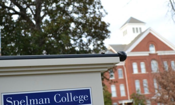 Spelman College sign with campus building in the background