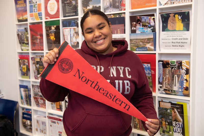 KIPP High School senior Lizbeth Garcia, 17, poses with Northeastern University's flag Monday, Dec. 9 in the Bronx, New York. (Barry Williams/for New York Daily News)