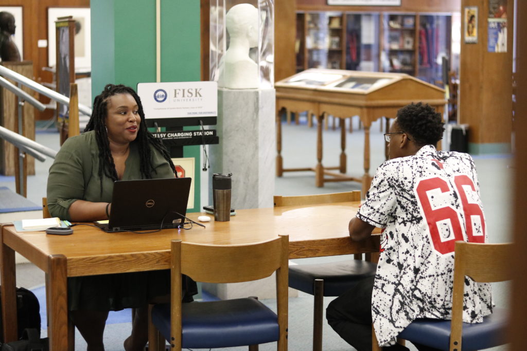 Holly Fakunle, a KIPP Nashville college persistence counselor, holds a check-in with Nicholas Ulumenfo, a student at Fisk University. (Fall 2019)
