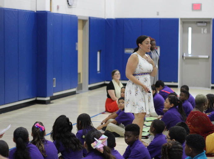 Principal Bridgit Cusato-Rosa speaks to her students at an assembly.
