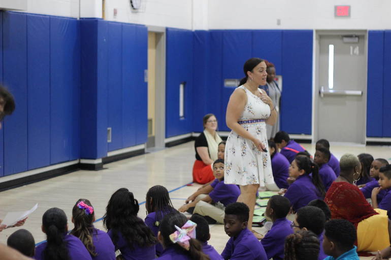 Principal Bridgit Cusato-Rosa speaks to her students at an assembly.
